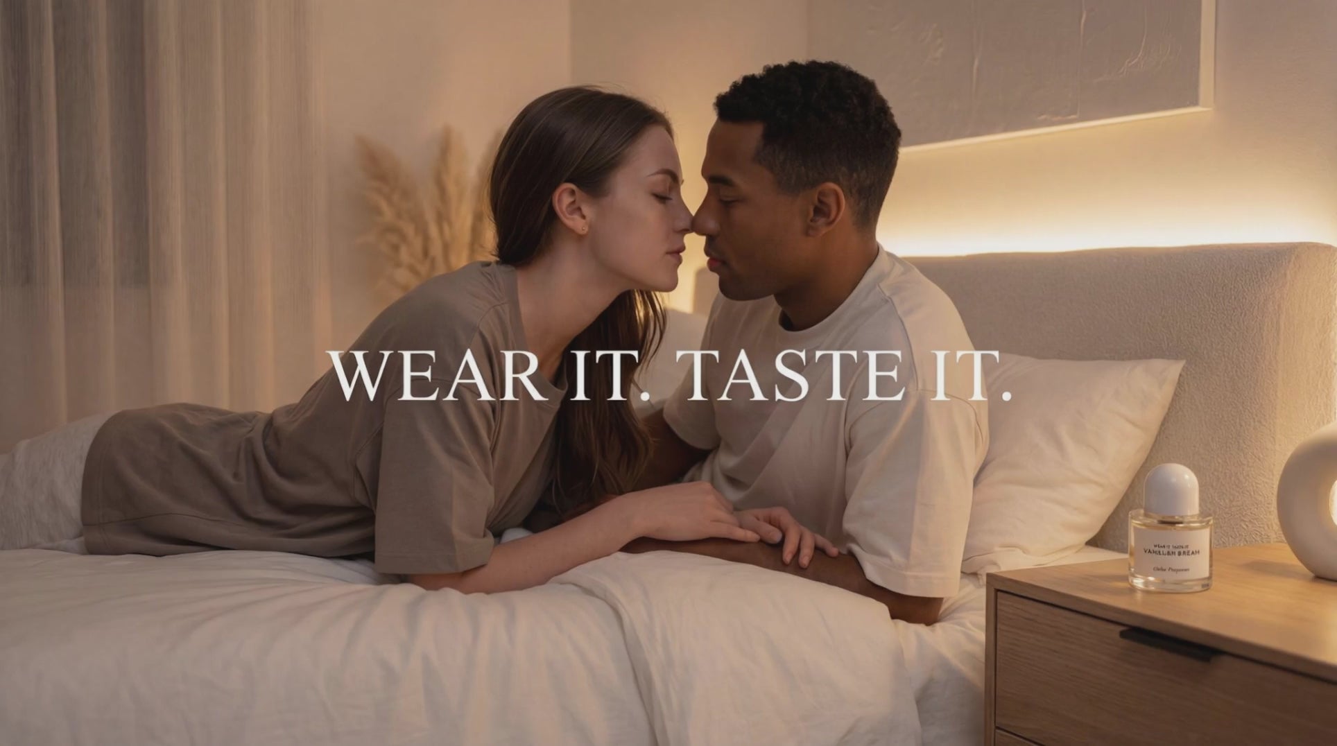 Load video: DOLCE NUDE brand positioning video - romantic couple on bed with warm lighting and fragrance bottle, text reads "wear it taste it"